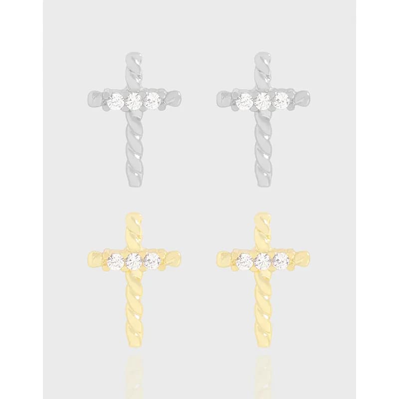 Polished cross-shaped stud earrings with a twisted rope stem and three small stones across the horizontal bar.