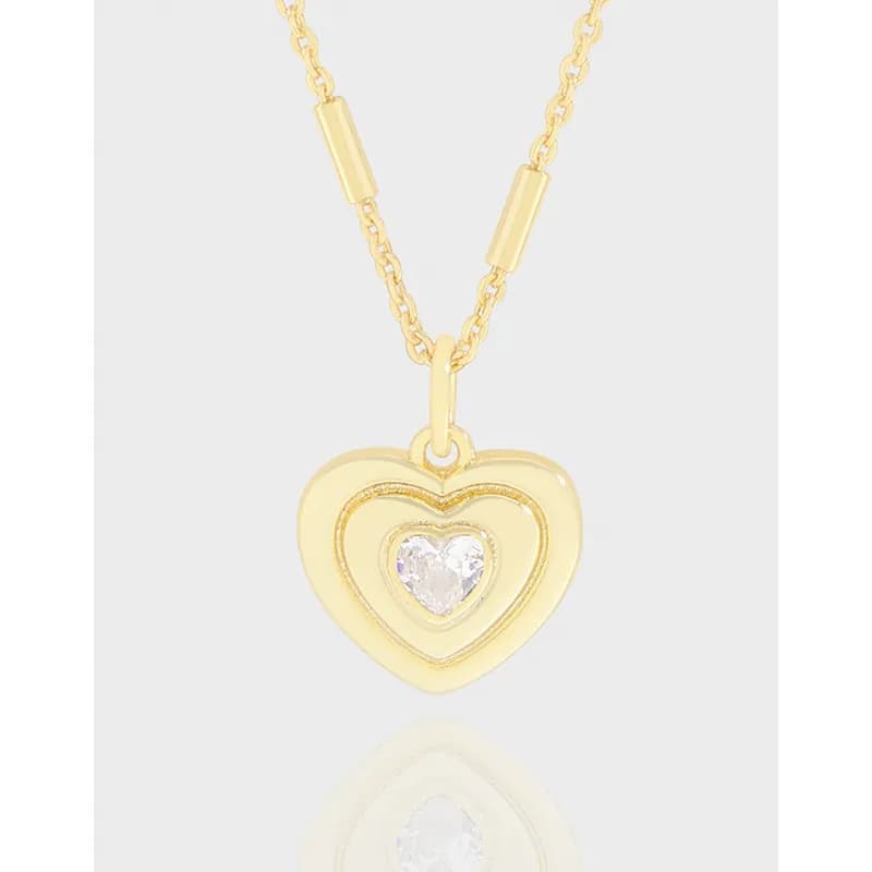 Polished silver double heart pendant on a delicate chain with a clear center stone