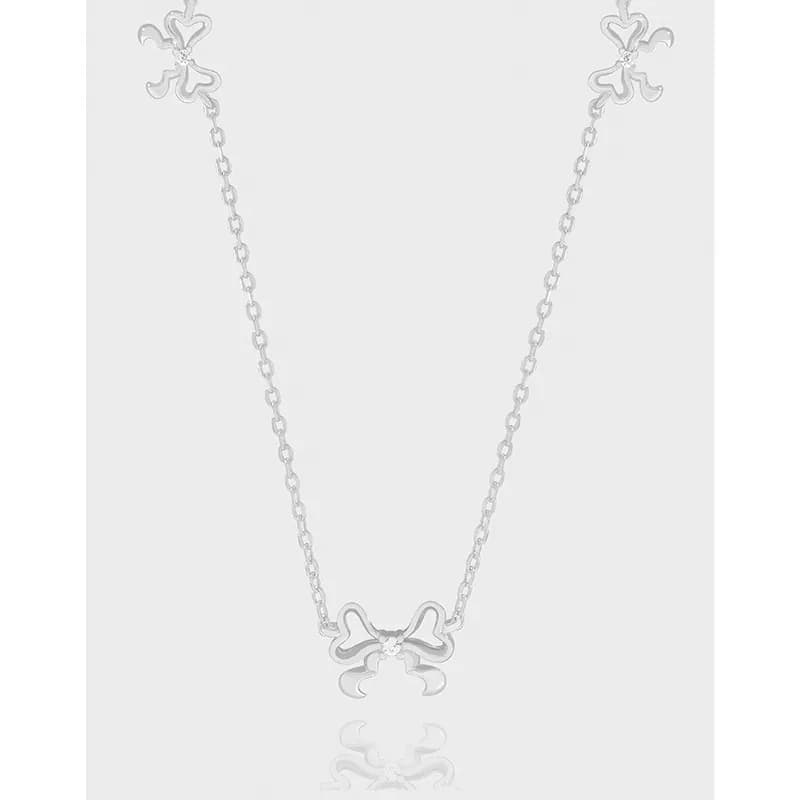 Delicate sterling silver necklace with a bow-shaped pendant on a fine chain