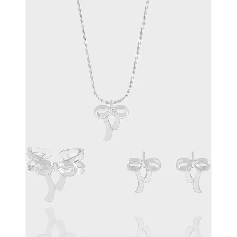 Polished sterling silver bow-shaped earrings on a light background