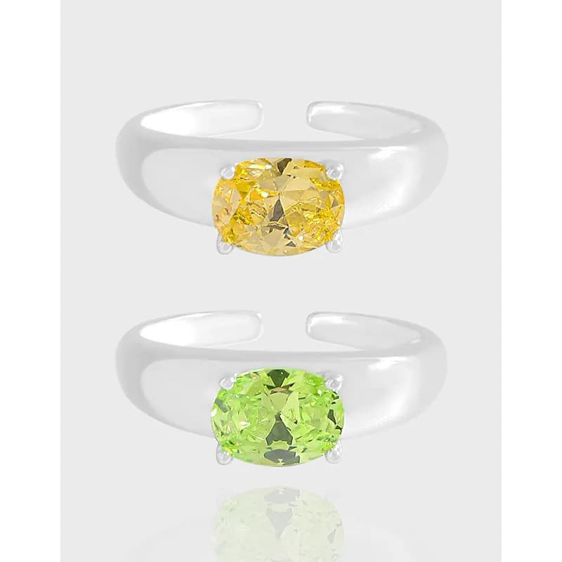 Open-cuff sterling silver rings featuring large oval gemstones in four-prong settings.