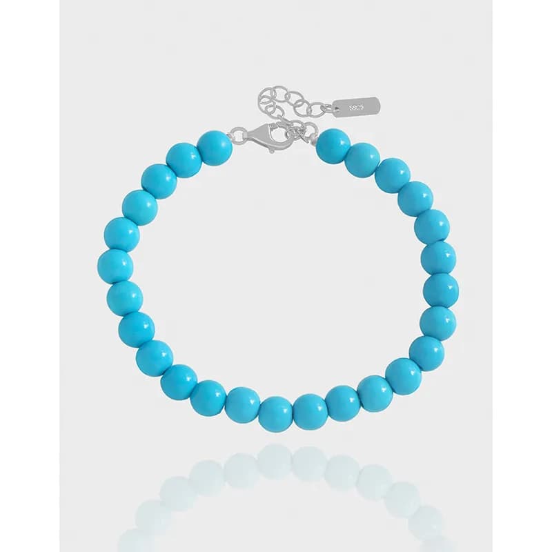 Bright blue beaded bracelet with a polished sterling-silver clasp and extender chain.