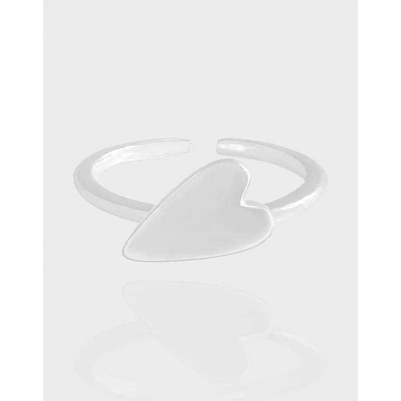 Polished sterling silver heart-shaped ring with an open adjustable band on a light background.