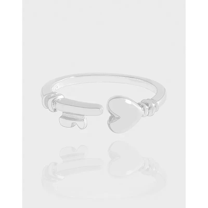 Polished sterling silver open ring with a heart on one end and a curved bar on the other.