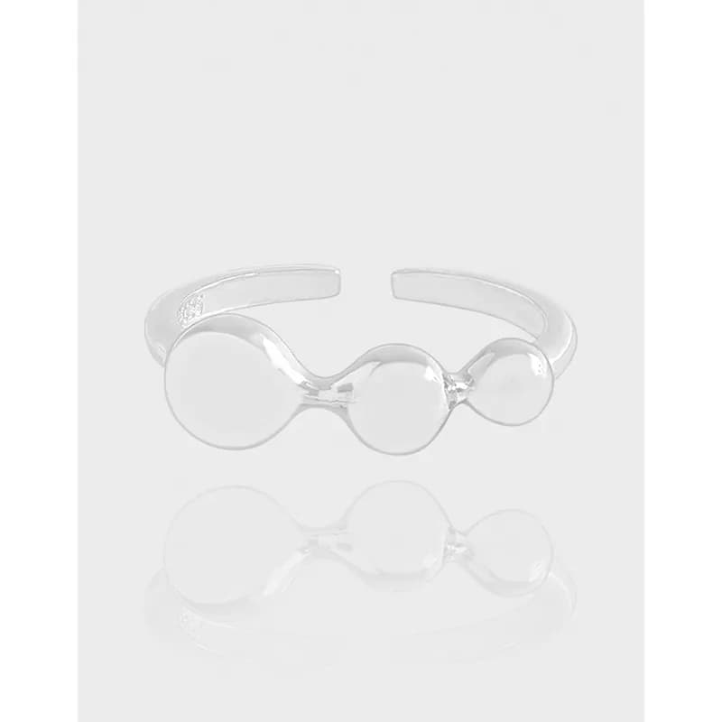 Polished sterling silver ring with three connected circular beads on an open band.