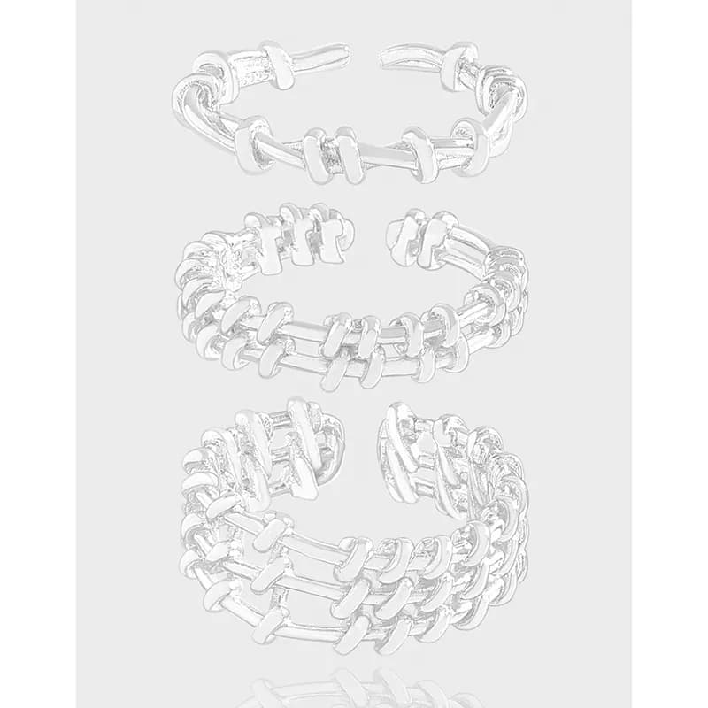 Polished sterling silver rings with interlocking bar-link design arranged as a stacked set.