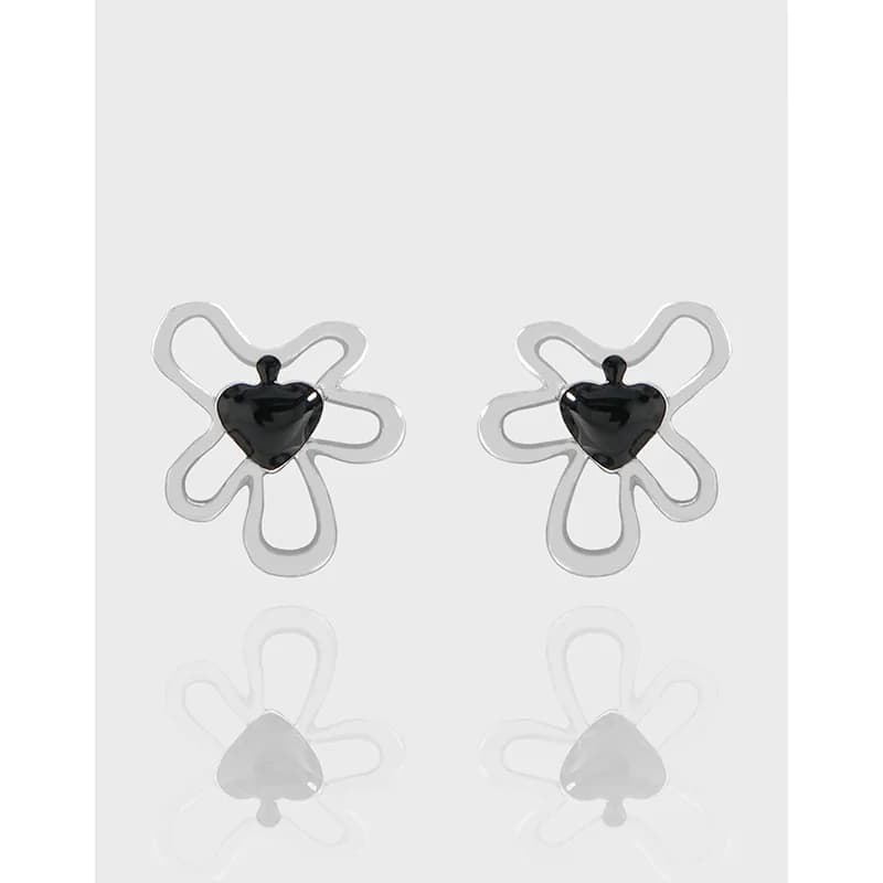 Sterling silver flower earrings with black heart centers shown on a light background.