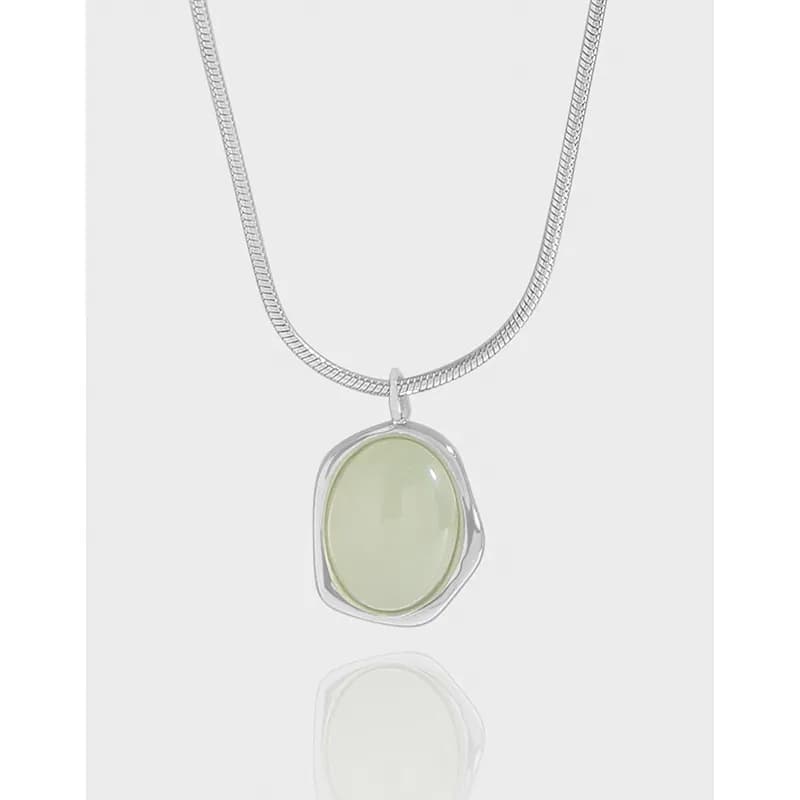 Sterling silver chain with a pale green oval cabochon pendant