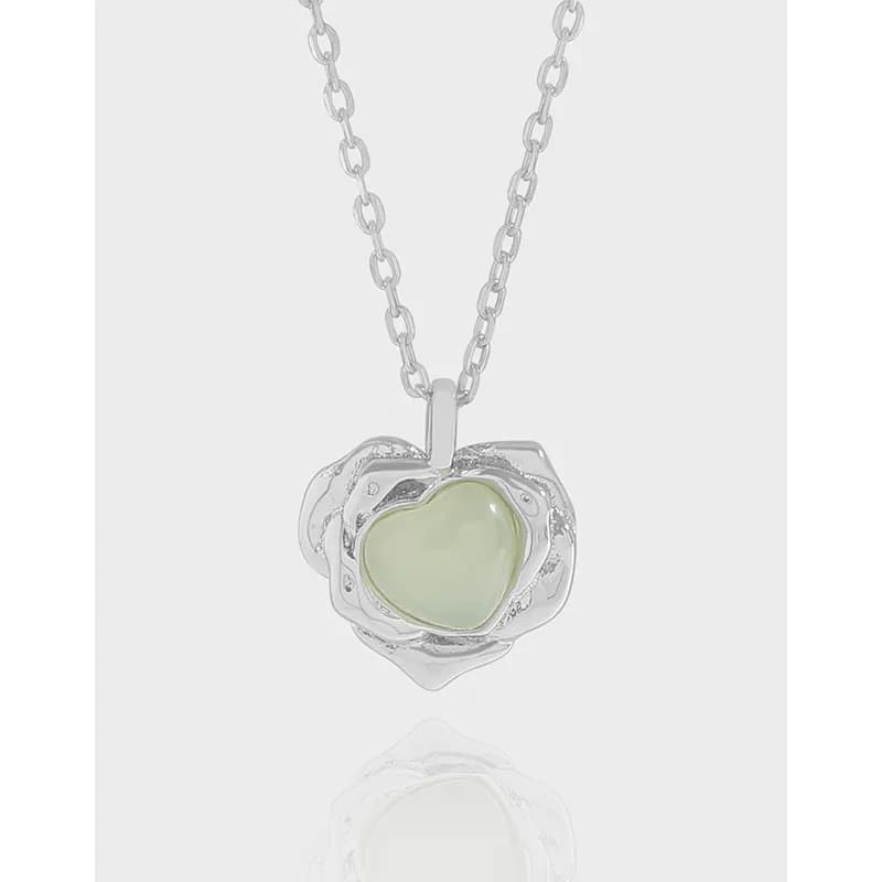 Silver heart-shaped pendant with pale green stone on a sterling silver chain