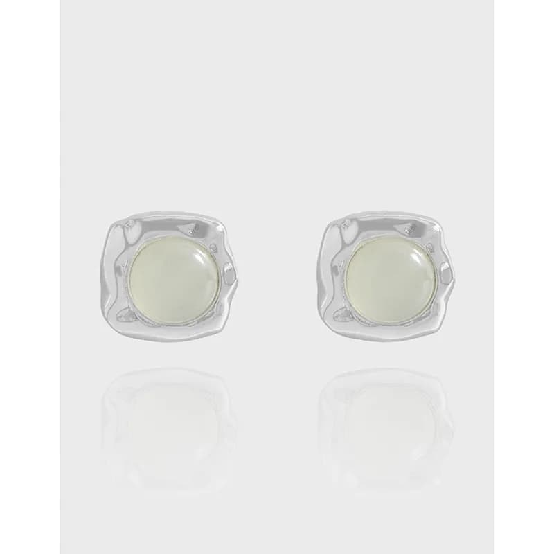 Pair of polished sterling silver square-bezel stud earrings with pale cabochon centers