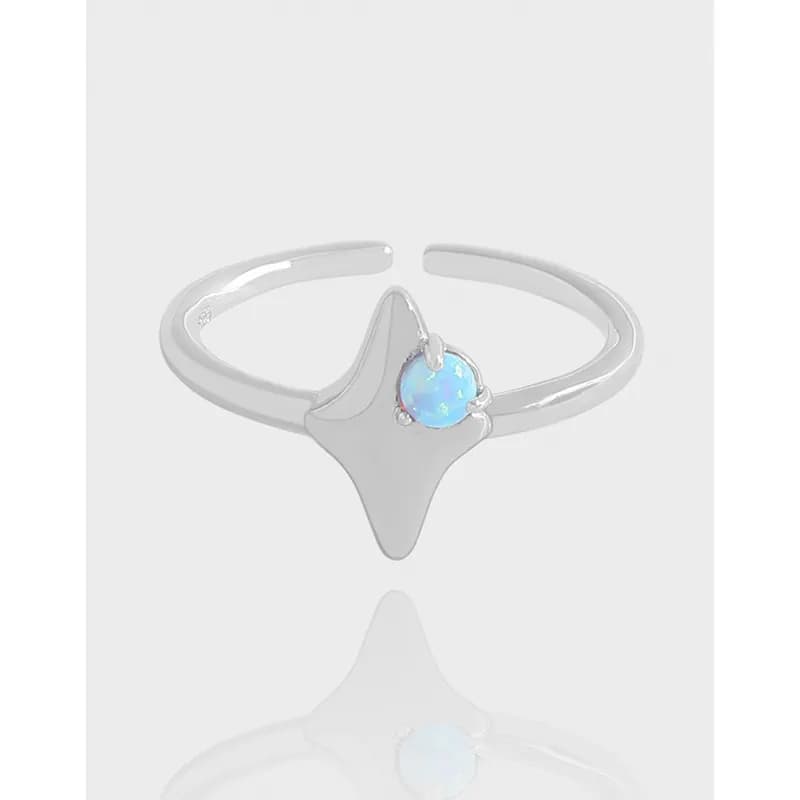 Polished sterling silver ring with an abstract teardrop centerpiece and a small blue opal prong-set at the top.