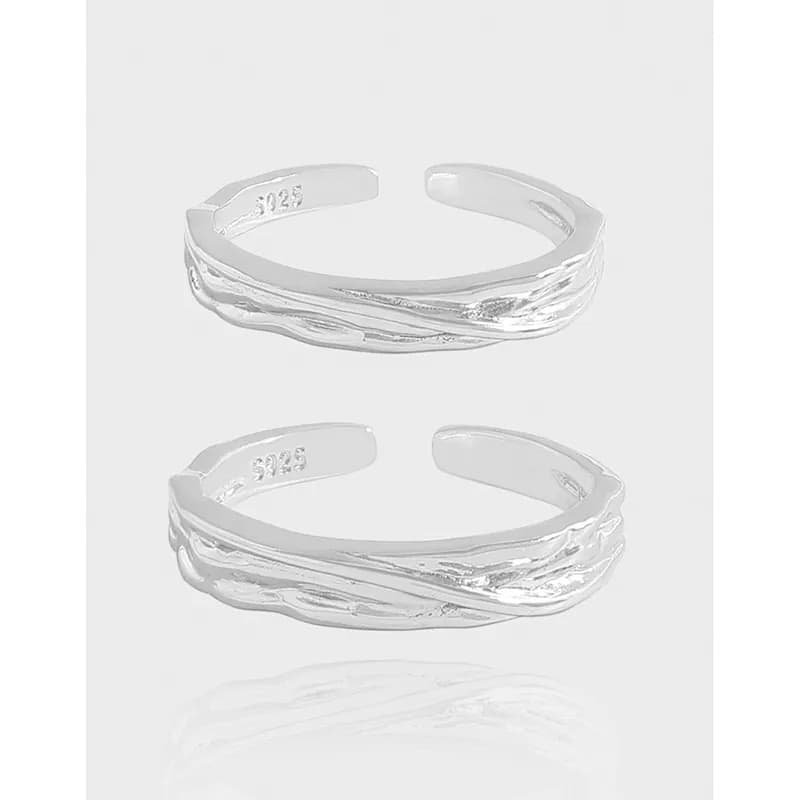 Open-ended sterling silver ring with braided wave texture and polished surface displayed from the side.