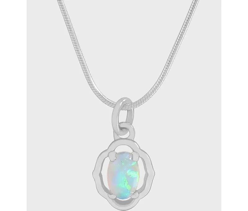 Polished sterling silver necklace with an oval opal pendant in a floral halo setting