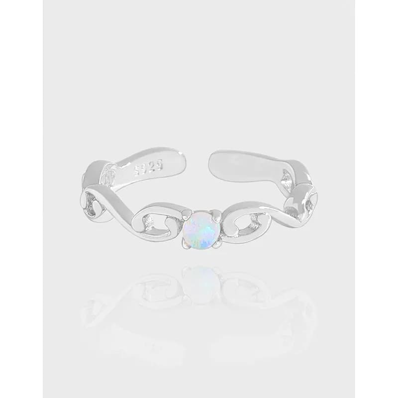 Open-ended silver ring with a central opal bezel-set in a linked chain motif