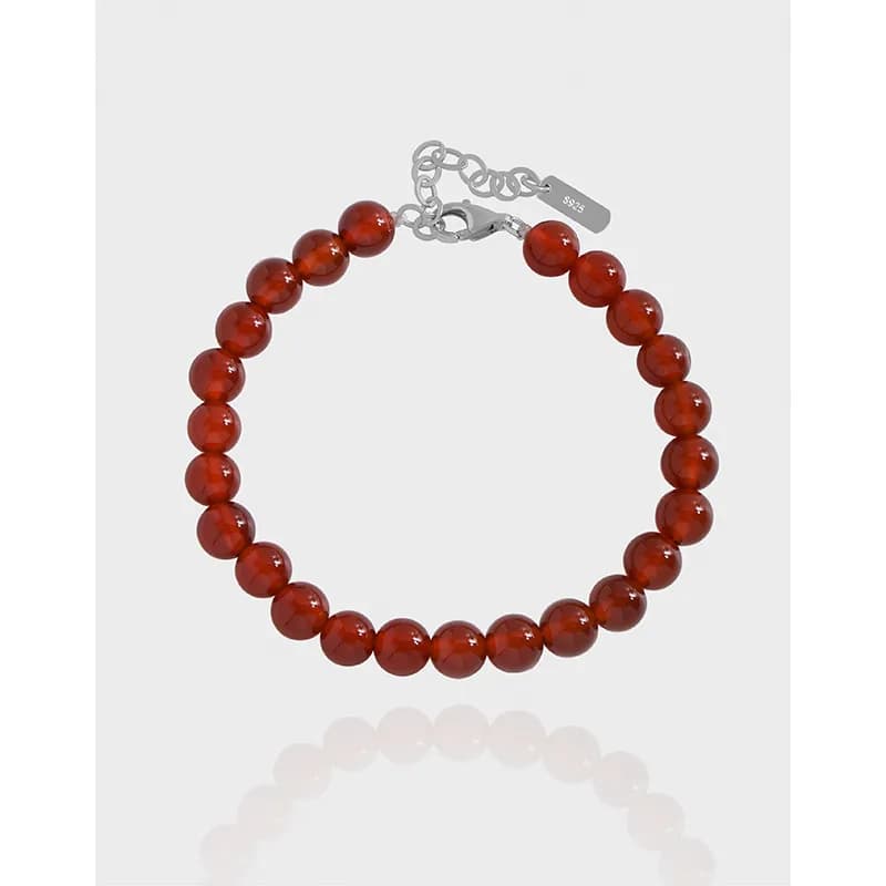 Polished sterling silver bracelet with red carnelian beads and adjustable extender chain.