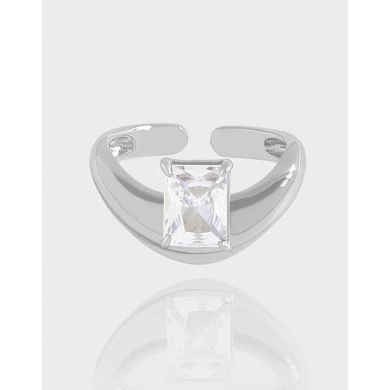 Polished sterling silver ring with a rectangular princess-cut gemstone set on a curved crescent band.