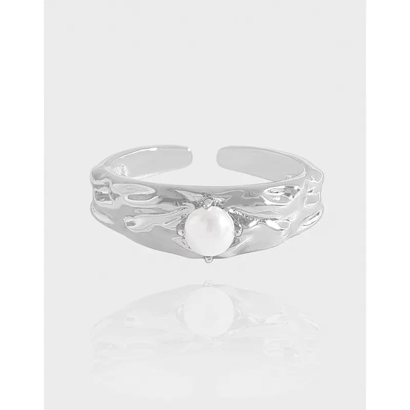 Polished sterling silver ring with a flowing organic band and a central pearl