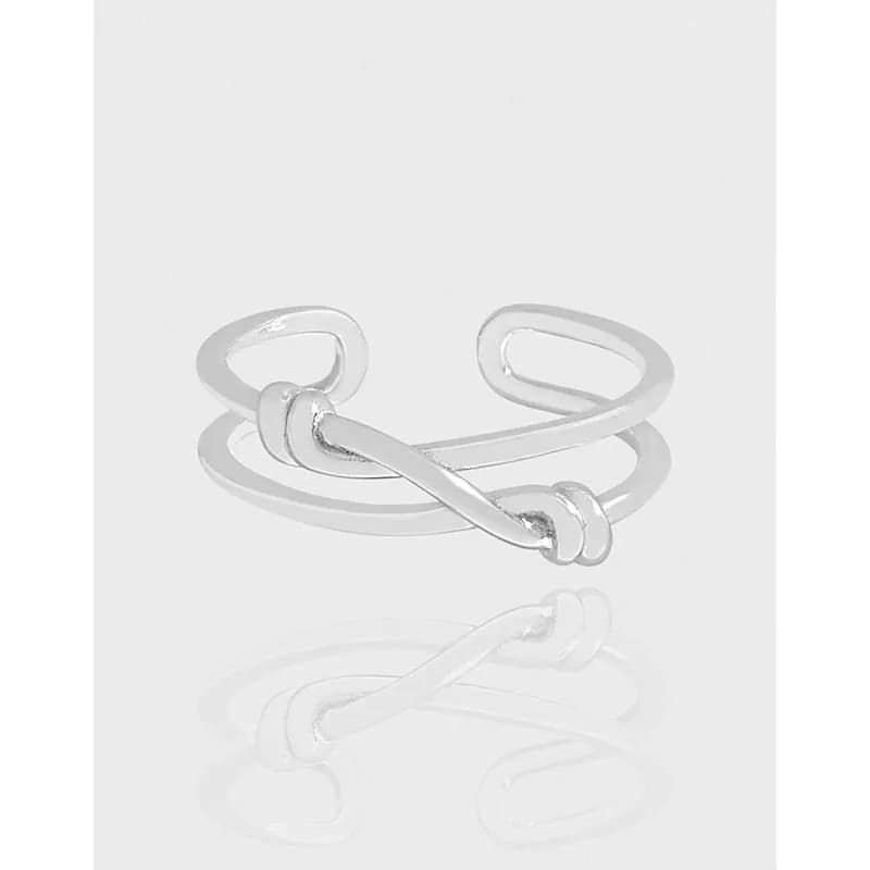 Polished sterling silver open-ring with a central knot and looping bands