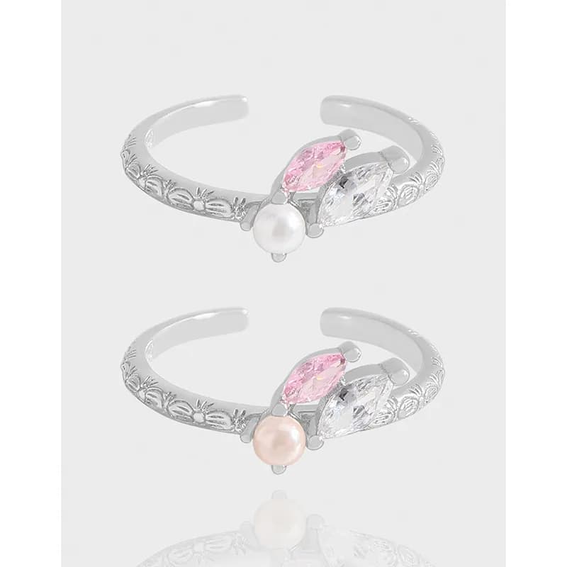 Open, floral-engraved sterling silver ring with pink and clear marquise stones and a pearl centerpiece.