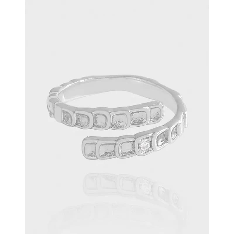 Double-wrap sterling silver ring with square-set pavé segments on each band.