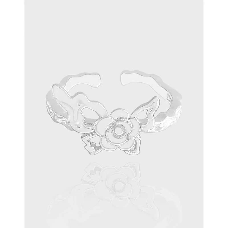 Polished sterling silver ring with an open cuff and a central floral rose motif