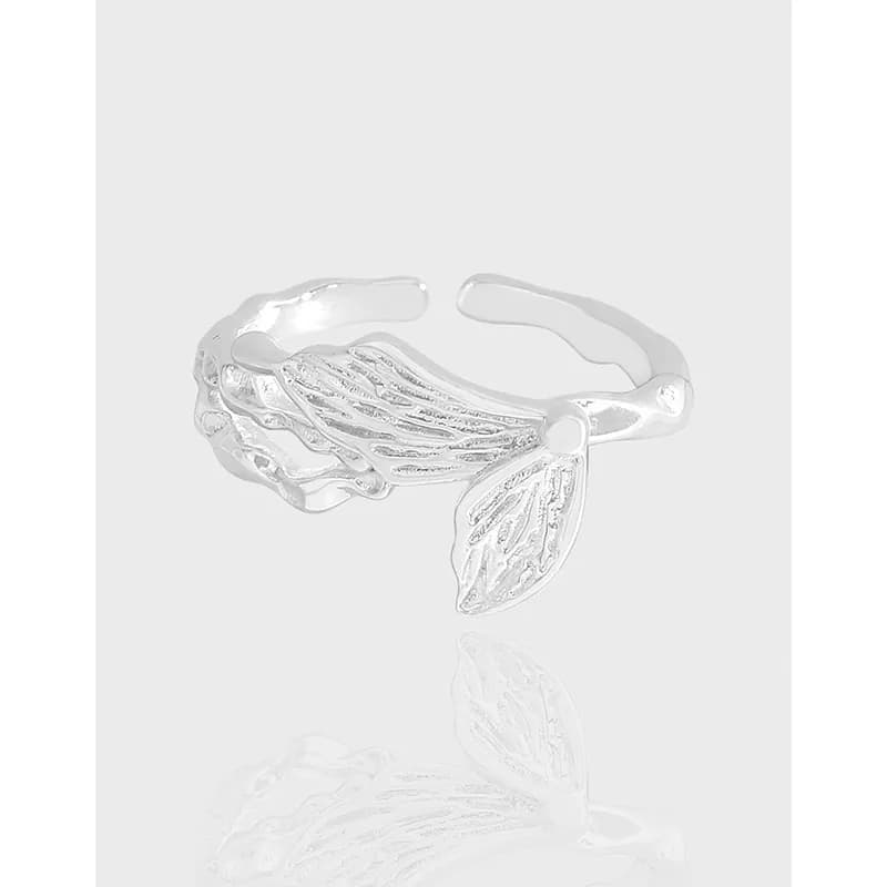 Polished sterling silver Winged Shell Ring displayed on a plain white background.