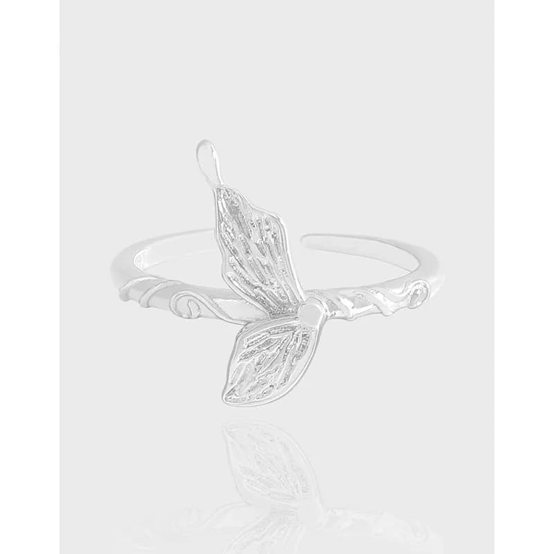 Polished sterling silver ring with a delicate butterfly wing motif perched on an open band.