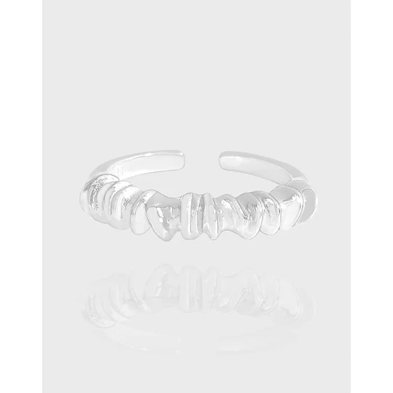 Polished sterling silver ring with a row of rounded discs along the top