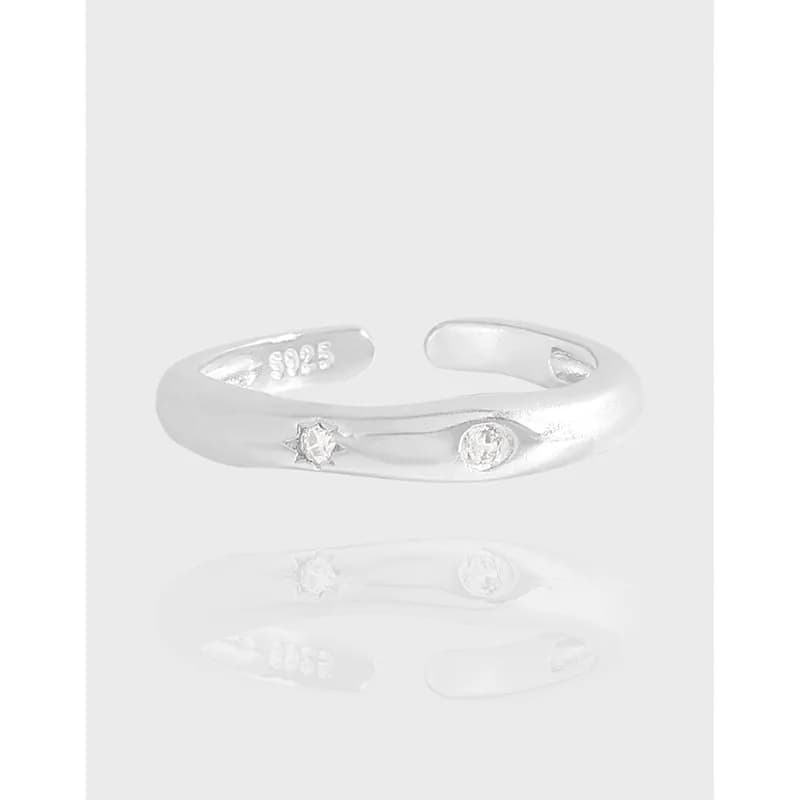 Polished Sterling Silver open wrap ring with star and round stone bezels on the outer surface.