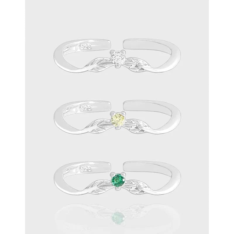 Polished sterling silver ring with a twisted leaf design and central gemstone