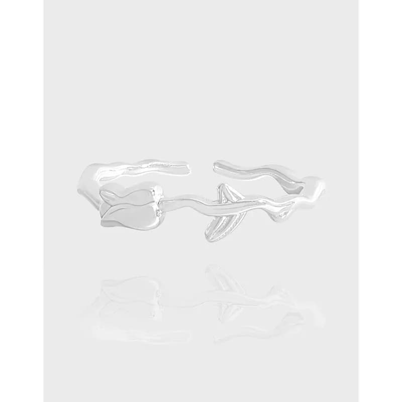 Polished sterling silver open ring with a stylized flower bud at one end and a flowing, curling band.