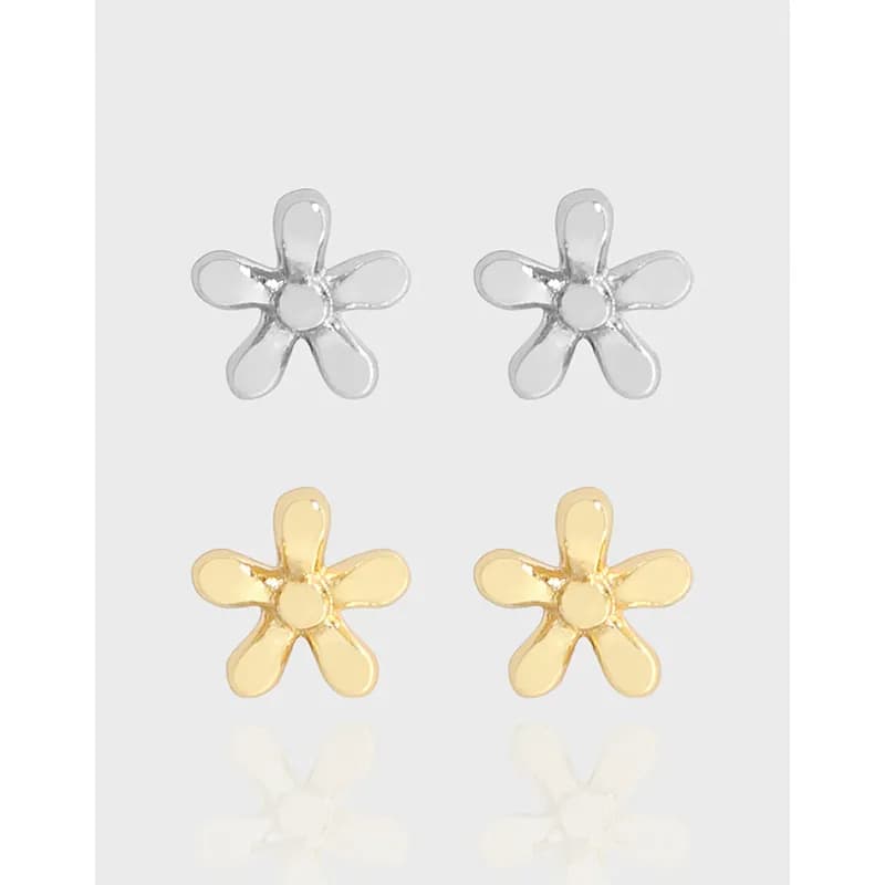 Silver and gold-tone five-petal flower stud earrings laid out in a grid.