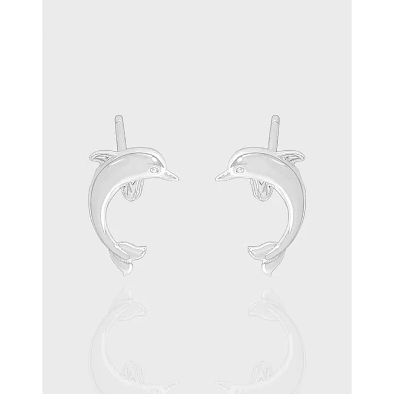 Pair of polished sterling silver dolphin arc earrings facing each other with posts