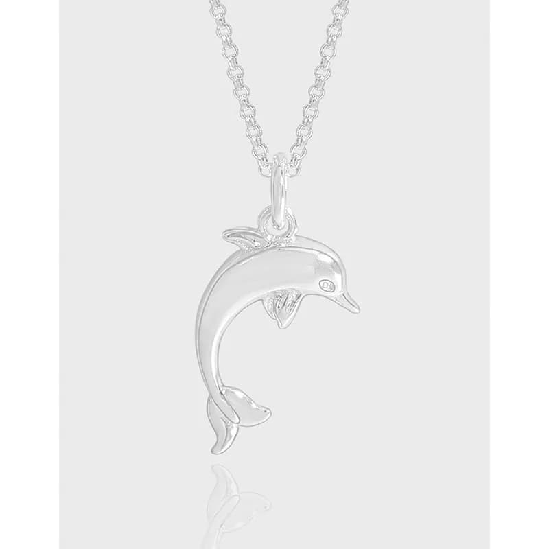 Polished sterling silver dolphin pendant on a delicate chain.