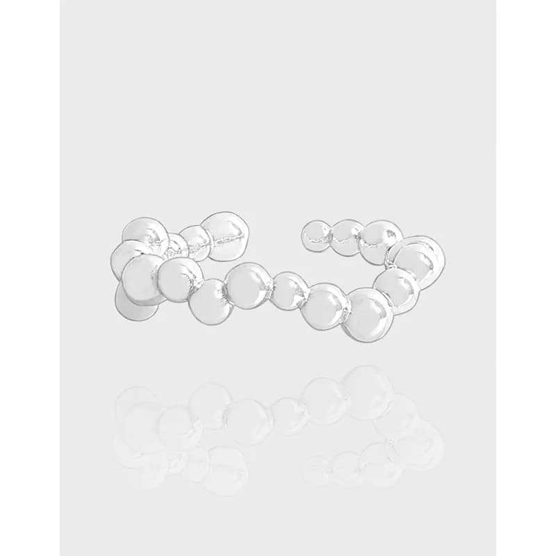 Open ring with interconnected polished silver discs forming a bubble-like band.