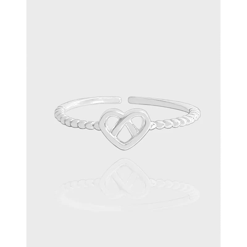 Polished sterling silver ring with a heart-shaped open centerpiece and a beaded rope-textured band.