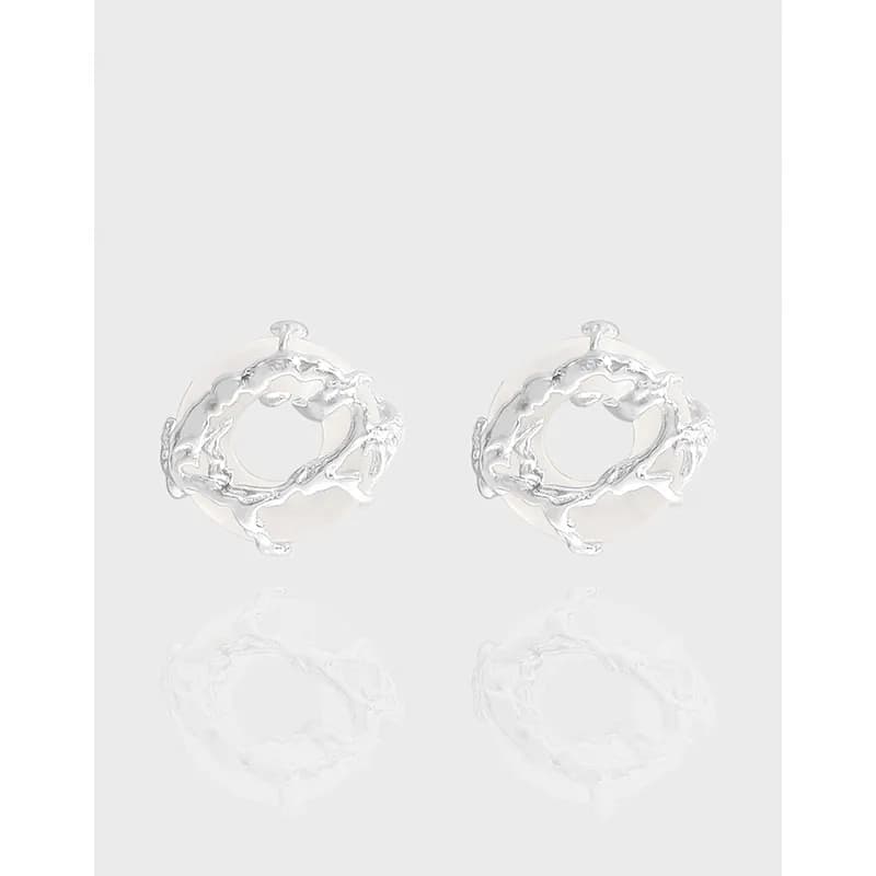 Polished sterling silver twig hoop earrings on a light gray background.