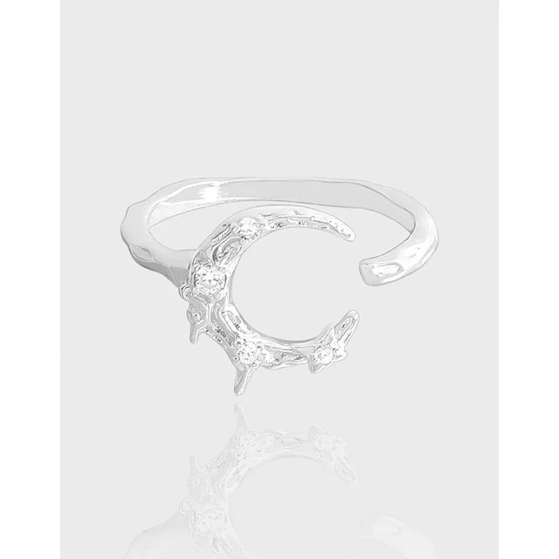 Polished sterling silver crescent moon ring with decorative detailing on the crescent, open band