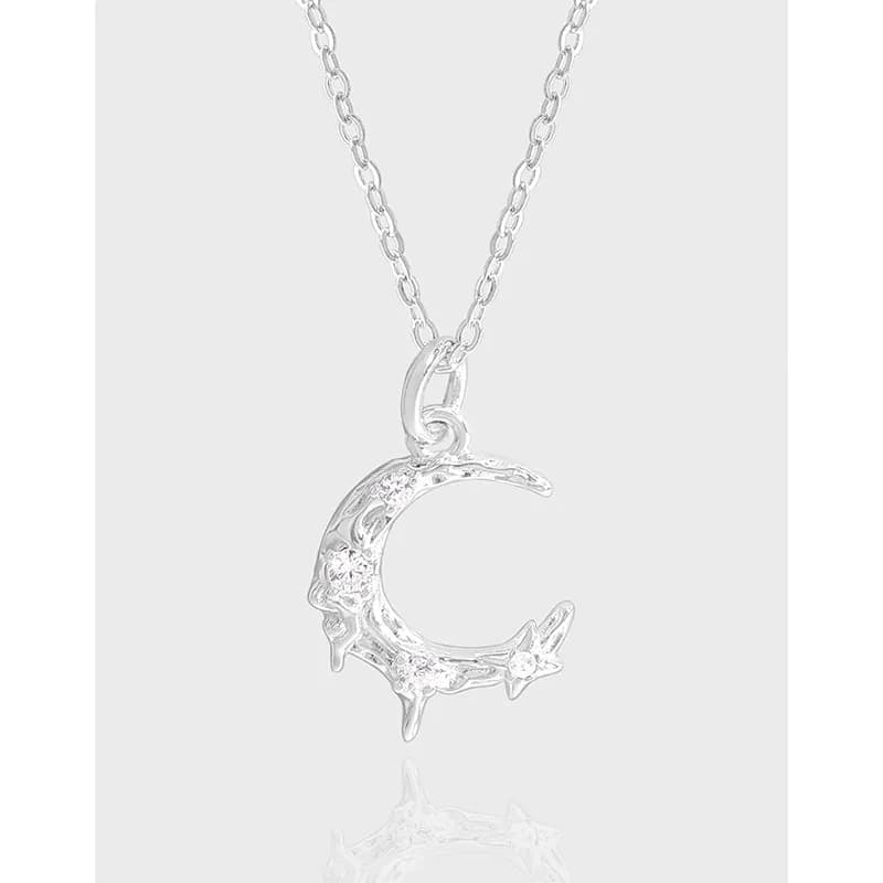 Polished sterling silver crescent moon pendant with a small star at the tip on a delicate chain.