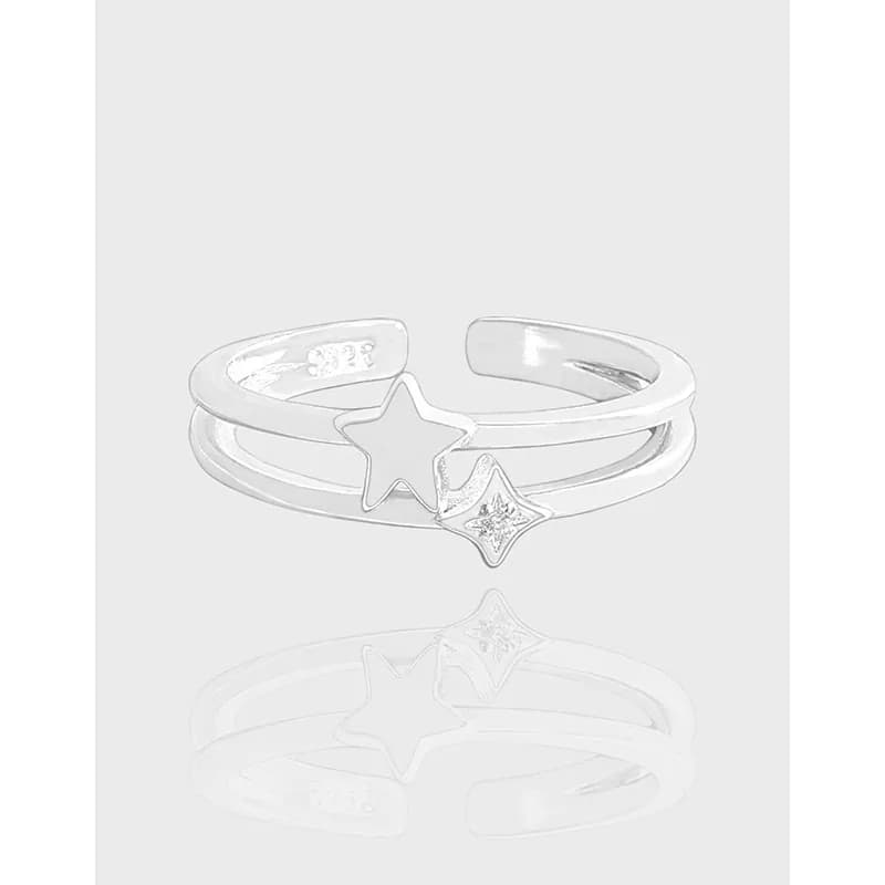 Polished sterling silver double-band ring featuring hollow star and star with stone motif