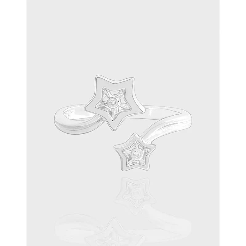 Open-ended sterling silver ring with two star motifs at each end and a central gem.