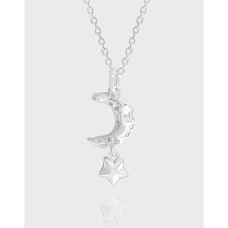 Polished sterling silver crescent moon pendant with a star charm on a delicate chain