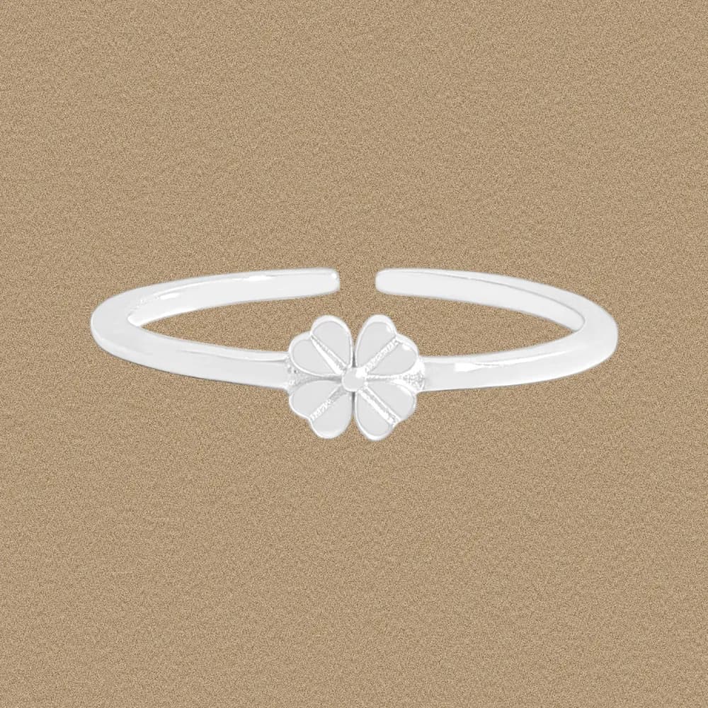 Polished sterling silver open-ring with a five-petal flower centerpiece on a textured background.