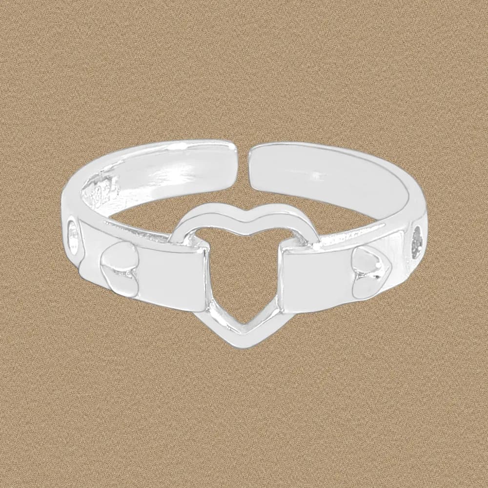 Polished sterling silver ring with a central open heart cutout on a neutral background.