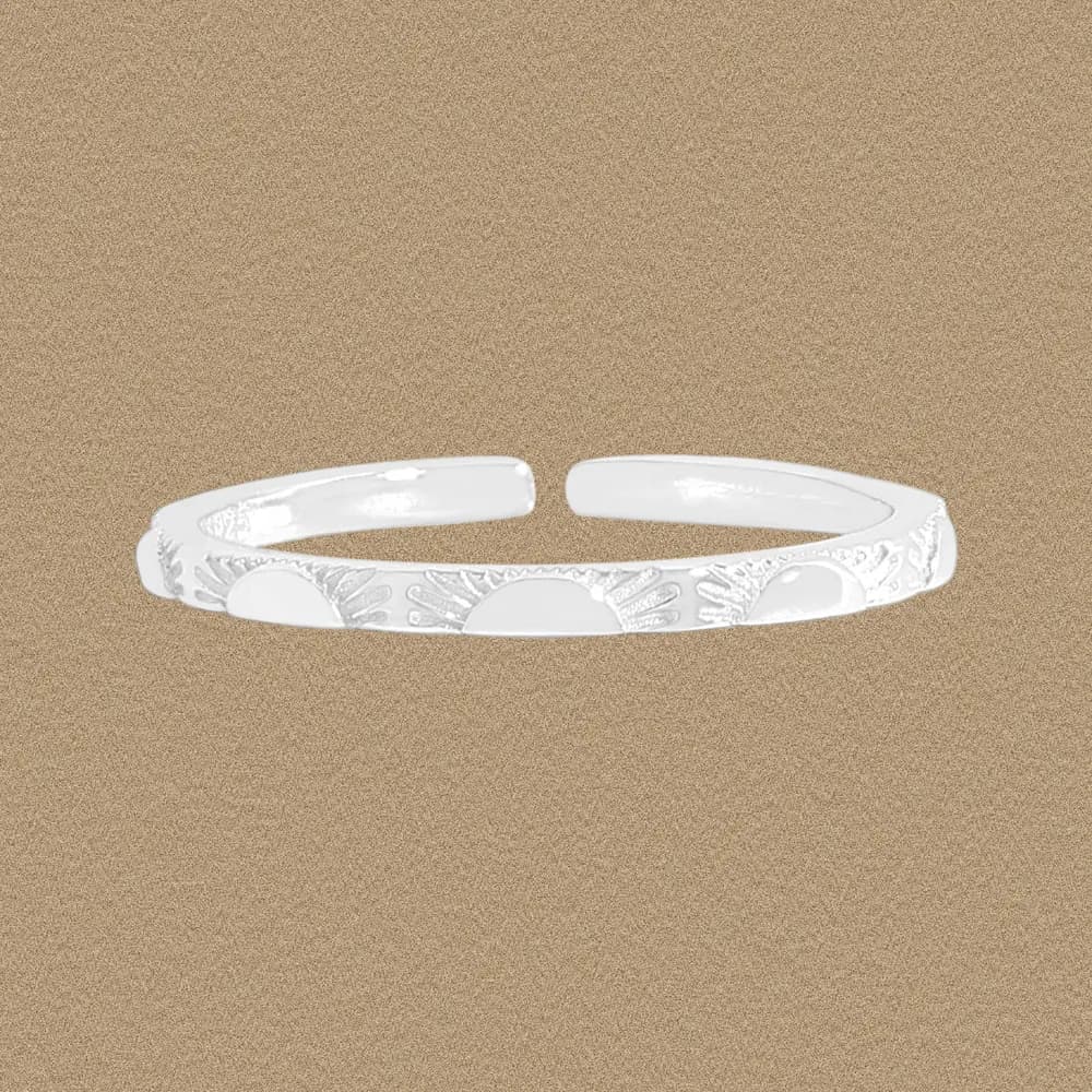 Polished sterling silver open-ring with a sunburst engraved pattern along the band.