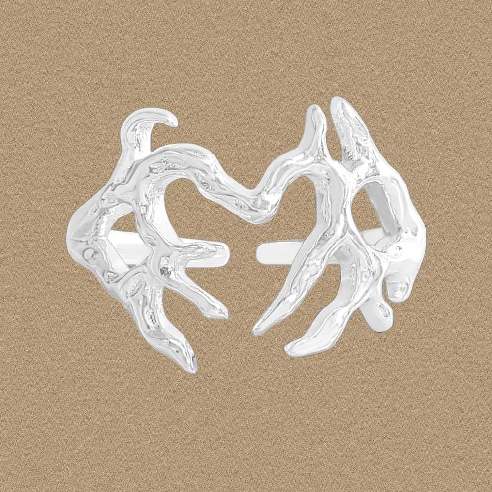 Polished sterling silver sculptural ring with irregular organic forms on a neutral background.