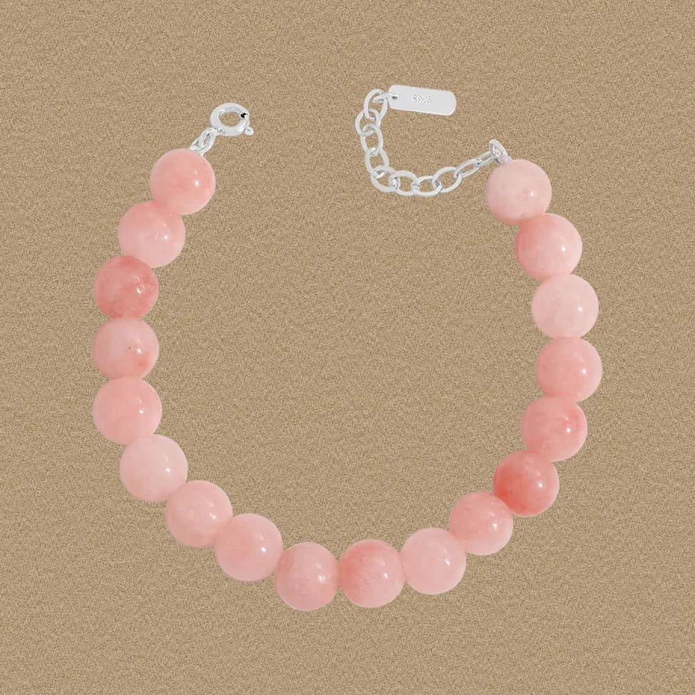 Polished sterling silver bracelet with round pink rose quartz beads and a small extender chain.