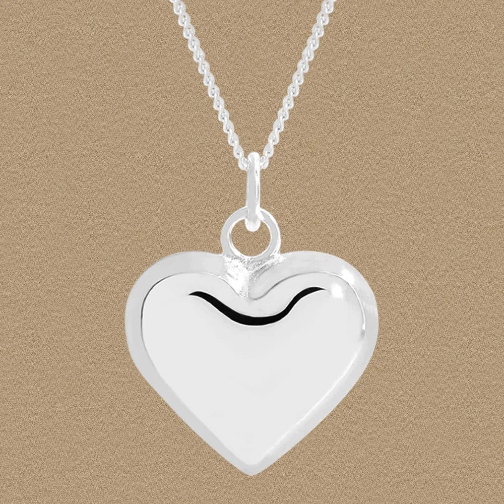 Polished silver heart pendant on a delicate chain, front view.