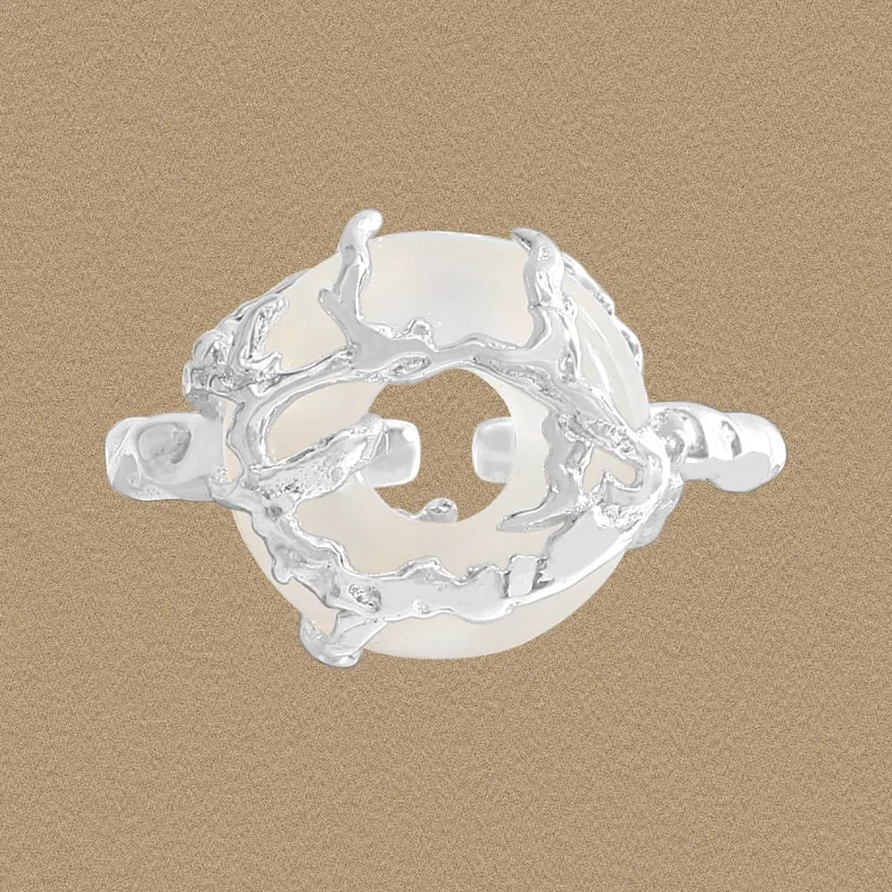 Sterling silver ring with a circular pearl centerpiece surrounded by irregular coral-like branches.