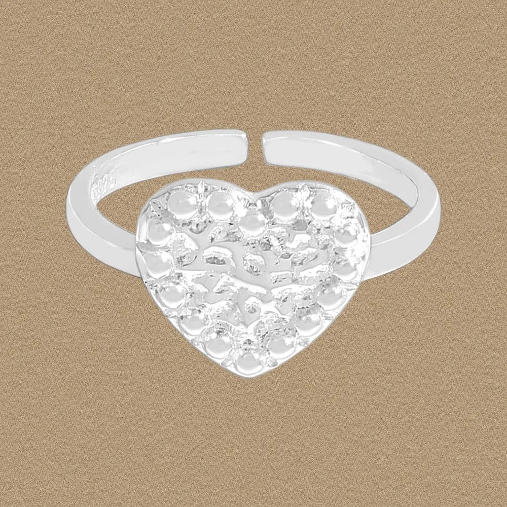 Sterling silver heart-shaped ring with an open band and dotted textured heart centerpiece.